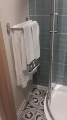 a bathroom with white towels and a shower at The Cozy Studio, Varna City Centre in Varna City