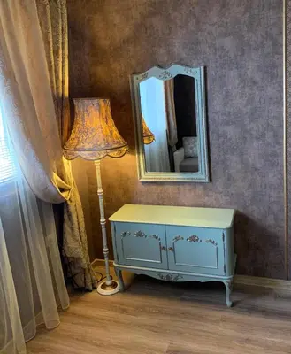 a dressing table with a lamp and a mirror at Boutique House Belevi in Nesebar