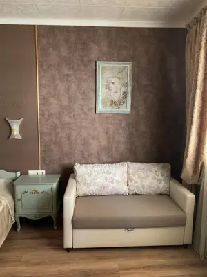 a living room with a couch and a bed at Boutique House Belevi in Nesebar