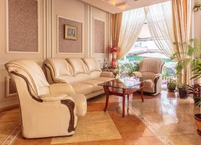 a living room with a couch and chairs and a table at Хотел БУТИК ИМПЕРИАЛ in Primorsko