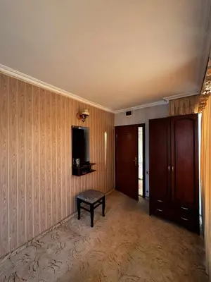 a living room with a tv and a bench in it at Хотел БУТИК ИМПЕРИАЛ in Primorsko