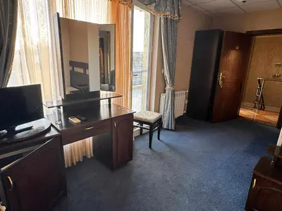a hotel room with a desk and a large window at Хотел БУТИК ИМПЕРИАЛ in Primorsko