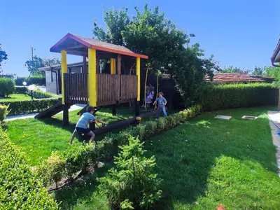 a group of children playing in a play house at BulgariaVilla - Sunny Hills Villas in Bryastovets