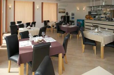 a restaurant with tables and chairs in a room at Byala Panorama Resort in Byala