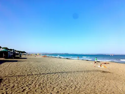a group of people on a beach with the ocean at Avelov Art Apartment in Burgas City