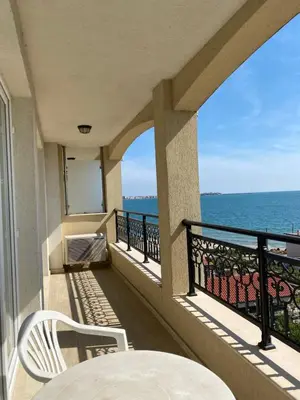 a balcony with a table and chairs and the ocean at Private Super apartments by sea in Apart Hotel ! in Pomorie