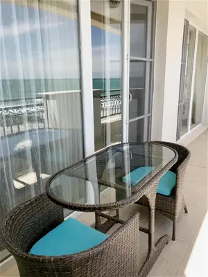 a glass table and two chairs on a balcony at Private Super apartments by sea in Apart Hotel ! in Pomorie