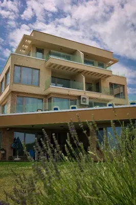 a tall building with chairs in front of it at Villa Flora in Sozopol