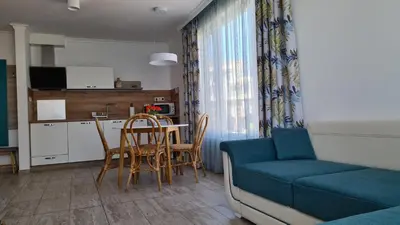 a living room with a couch and a table and chairs at Villa Flora in Sozopol