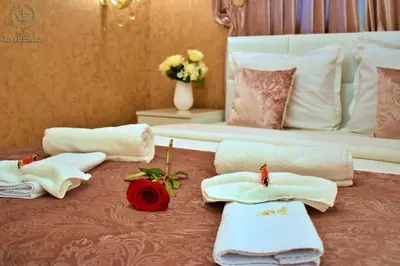 a room with towels and a bed with a mirror at Hotel IMPERIA in Varna City