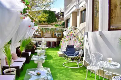a balcony with green grass and tables and chairs at Hotel IMPERIA in Varna City