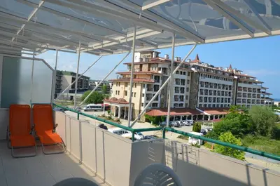 a balcony with chairs and a view of a building at Sania in Obzor