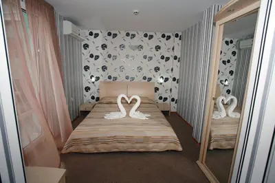 a bedroom with two swans on a bed with a mirror at Sania in Obzor