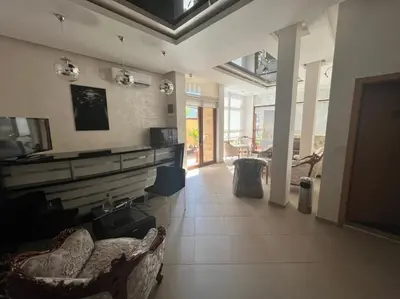 a large living room with couches and a tv at Time out in Sozopol
