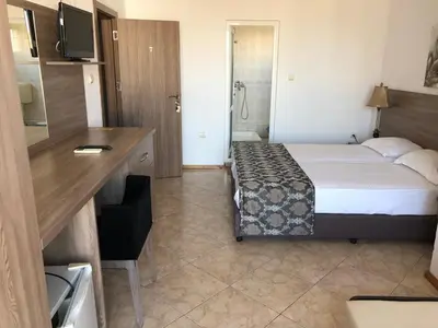 a hotel room with a bed and a bathroom at Time out in Sozopol