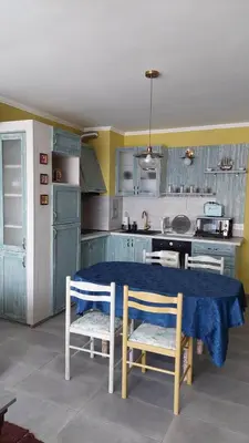 a kitchen with a blue table and chairs in it at Anthic 7 Apartment 3 in Sozopol