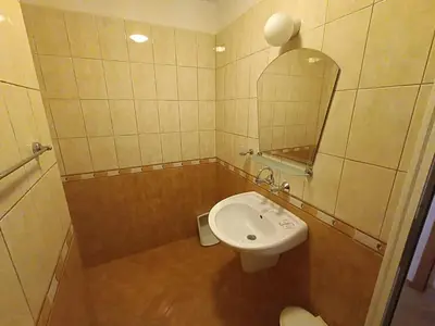 a bathroom with a white sink and a mirror at Tony Guest House in Sozopol