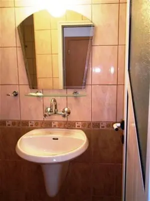 a bathroom with a sink and a mirror at Tony Guest House in Sozopol