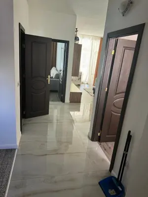 a hallway with two sets of doors and a tile floor at Апартамент на солнечном берегу in Sunny Beach