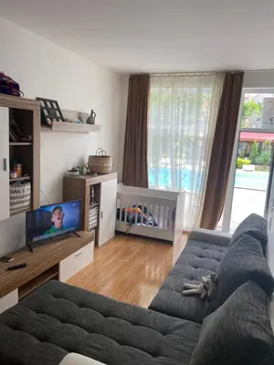a living room with a couch and a tv at Апартамент на солнечном берегу in Sunny Beach