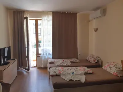 a hotel room with two beds and a television at Hotel Royal Dreams Privat Apartment in Sunny Beach
