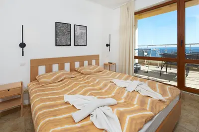 a bedroom with a bed with towels on it at Infinity Terrace 1BR Apartment Nessebar in Nesebar