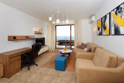 a living room with a couch and a desk at Infinity Terrace 1BR Apartment Nessebar in Nesebar