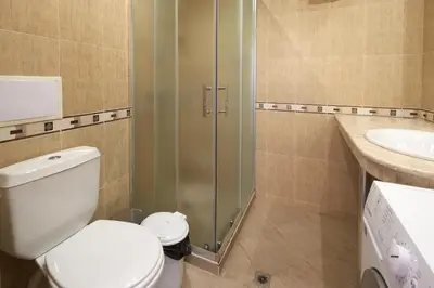 a bathroom with a toilet and a sink at Infinity Terrace 1BR Apartment Nessebar in Nesebar