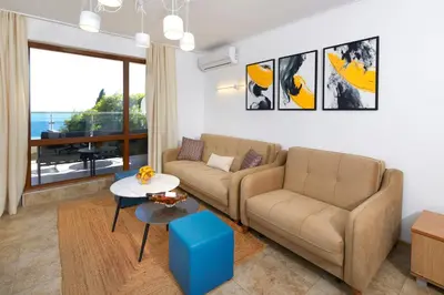 a living room with a couch and a table at Infinity Terrace 1BR Apartment Nessebar in Nesebar