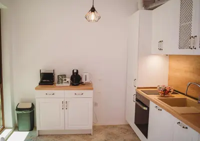 a kitchen with white cabinets and a sink at Andreya's Sea apartment-Beach, Sea garden ,Old Town, Free Parking, Free EVcharging Station in Varna City