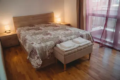 a bedroom with a bed and a chair and a window at Andreya's Sea apartment-Beach, Sea garden ,Old Town, Free Parking, Free EVcharging Station in Varna City