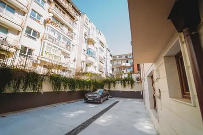 a car parked in a parking lot next to a building at Andreya's Sea apartment-Beach, Sea garden ,Old Town, Free Parking, Free EVcharging Station in Varna City