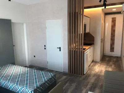 a bedroom with a bed and a sink and a door at Hotel Pacific Palma in Sunny Beach
