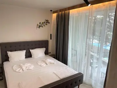 a bedroom with a bed with two towels on it at Hotel Pacific Palma in Sunny Beach