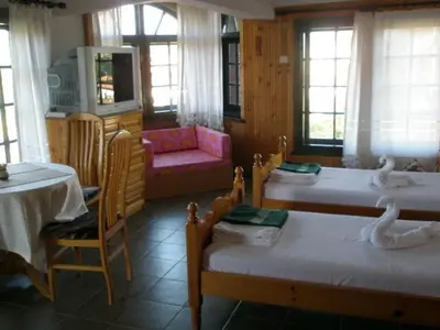 a room with three beds with swans on them at Апартамент КИМАКО, 100м2 на цена за хотелска стая за двама in Tsarevo