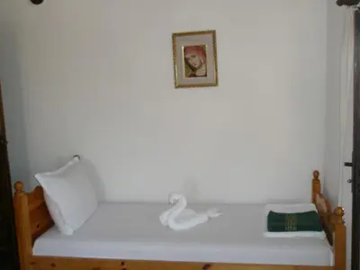 a white bed with a picture on the wall at Апартамент КИМАКО, 100м2 на цена за хотелска стая за двама in Tsarevo