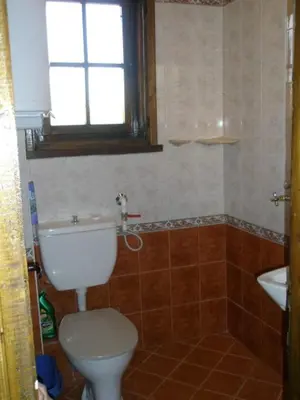 a bathroom with a toilet and a sink at Апартамент КИМАКО, 100м2 на цена за хотелска стая за двама in Tsarevo