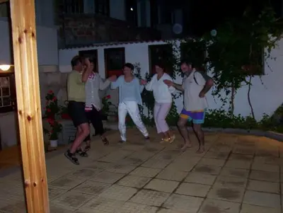 a group of people dancing on a patio at night at Апартамент КИМАКО, 100м2 на цена за хотелска стая за двама in Tsarevo