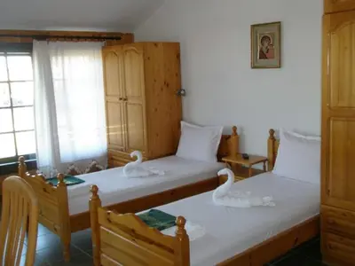 two beds in a room with swans on them at Апартамент КИМАКО, 100м2 на цена за хотелска стая за двама in Tsarevo