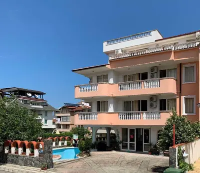 a building with a swimming pool in front of it at Guest Rooms Nia Elis Kiten in Burgas City