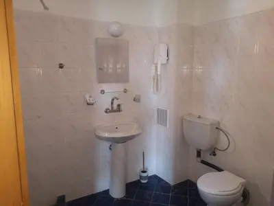 a bathroom with a toilet and a sink and a phone at Алми Almi in Sveti Vlas