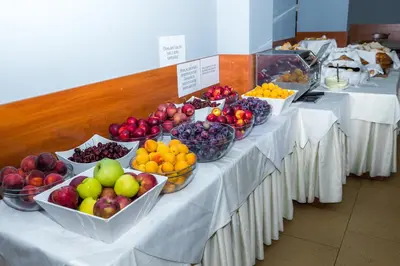 a row of tables with bowls of fruit on them at Sun Palace Hotel - All Inclusive in Sunny Beach