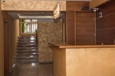 a kitchen with a counter and a stairway at Луксозен апартамент Свети Влас Вила Аристо in Sveti Vlas