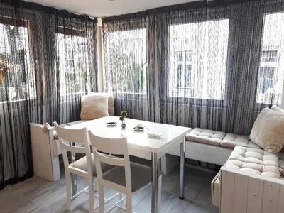 a living room with a table and chairs and a couch at Top Center 4-Bedroom Apartment in Varna City