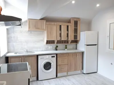 a kitchen with a white refrigerator and a dishwasher at Top Center 4-Bedroom Apartment in Varna City