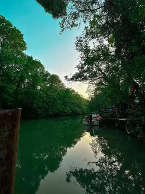 a river with a boat and trees on it at “River Romance” Villa in Kamchia