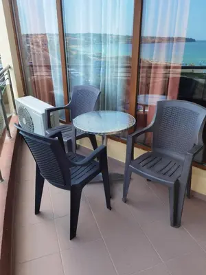 two chairs and a table and a table and chairs on a balcony at Свети Зосим in Sozopol