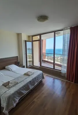 a bedroom with a bed and a view of the ocean at Свети Зосим in Sozopol