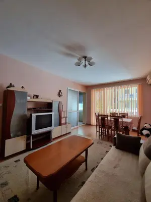 a living room with a couch and a table at Нашето място in Pomorie