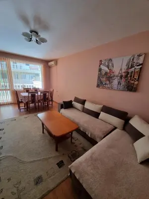 a living room with a couch and a table at Нашето място in Pomorie